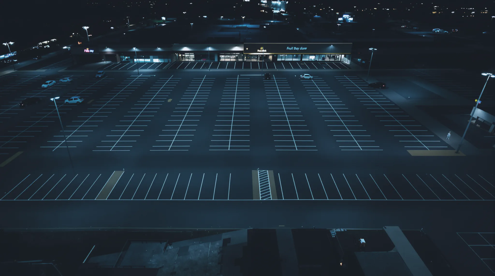 High-angle drone view over a large site at night.
